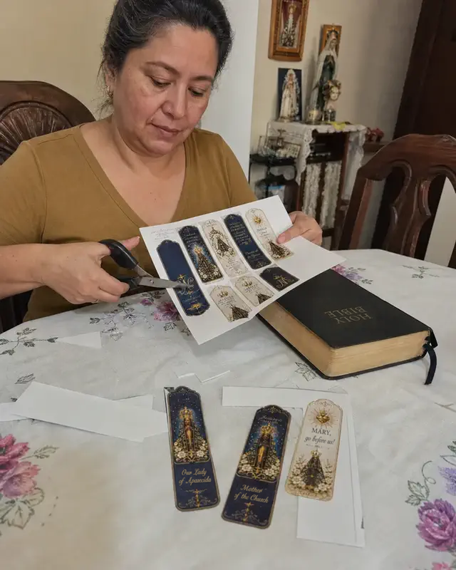 Woman cutting out her Catholic bookmarks